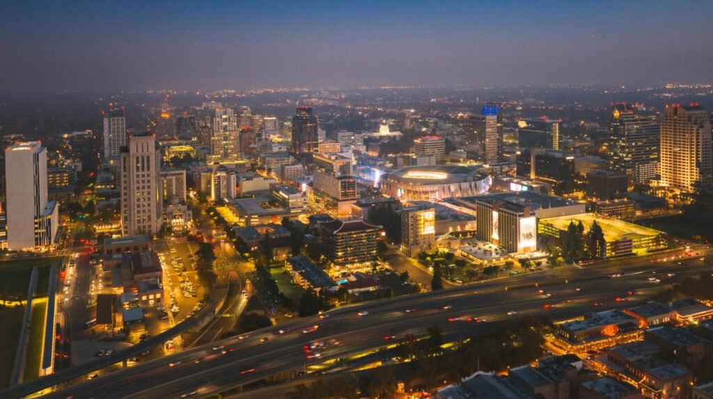 Stunning aerial view of Sacramento's city skyline illuminated at night, showcasing bustling urban life.